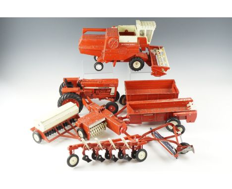 A group of The ERTL Company diecast farm toys, including a combine harvester, a tractor, trailers, etc, tallest 18.5 cm