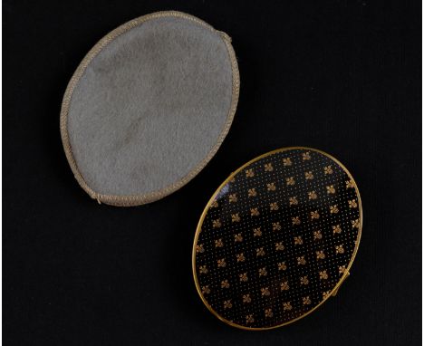 A vintage Scholl powder compact, decorated with fleur-de-lys, in felt slip cover, 8.5 x 7 cm