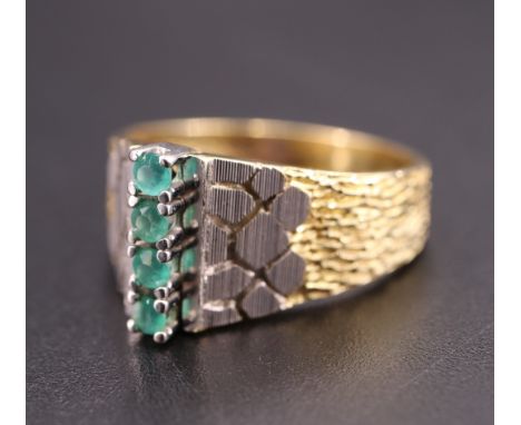 A 1970s French emerald and yellow metal ring, having four 2 mm brilliants transverse set in a line on a linear base, between 