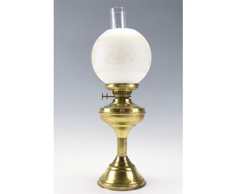 A brass oil lamp with an etched glass globe, 56 cm