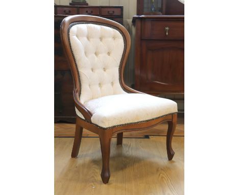 A contemporary reproduction Victorian button-upholstered spoon back boudoir chair