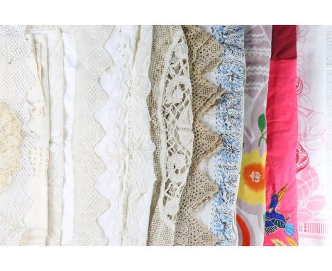 A quantity of antique and vintage domestic textiles including tablecloths, doilies, linen and crochet-work hand towels, etc