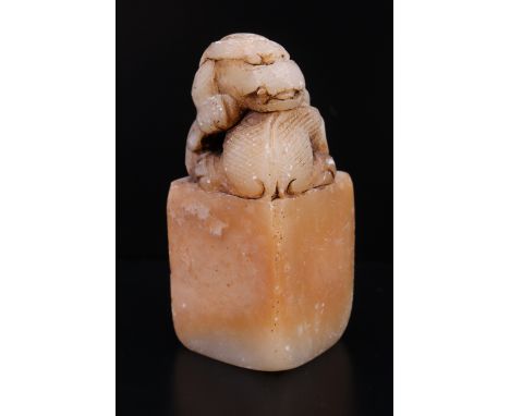 A Chinese carved soapstone seal, its top carved as a dragon, 52 mm