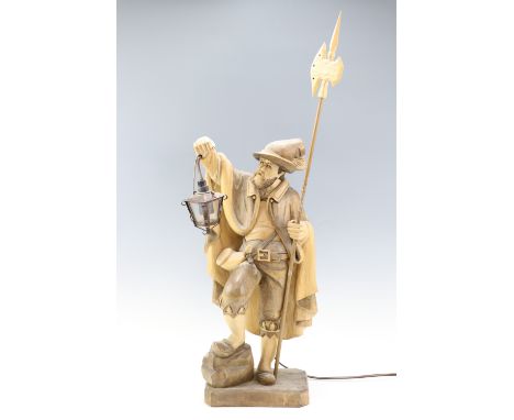 A carved wood figural German table lamp in the form of a night watchman, 77 cm