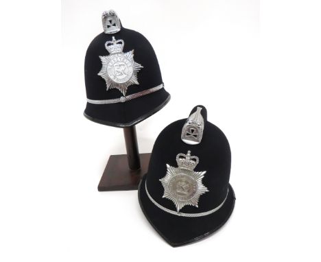 Two Post 1953 Police Constabulary Helmetsblack felt covered, crested top helmets.  Pointed peaks and rounded rear brim.  Plat