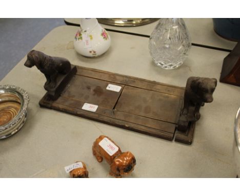 Carved and stained pine 'Black Forest' book trough with dog ends