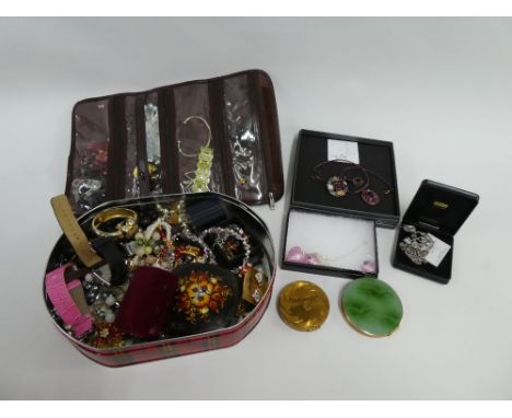 A large quantity of costume jewellery to include dress rings, beads, bracelets and brooches together two vintage powder compa