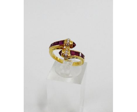 18 carat gold ruby and diamond set dress ring of crossover design, UK ring size K, stamped 750