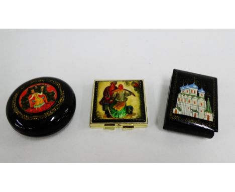 Two Russian lacquered trinket boxes, together with a gilt metal mirror compact, largest 8cm long, (3) 