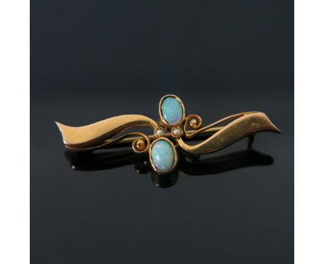 An 18 carat gold and opal brooch, two opposing open coiled tendril wings with two oval cabochon opals and seed pearls, stampe