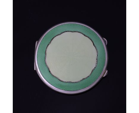 A George VI silver and enamelled compact, Joseph Gloster Ltd., Birmingham 1944, circular with a central pale green guilloche 