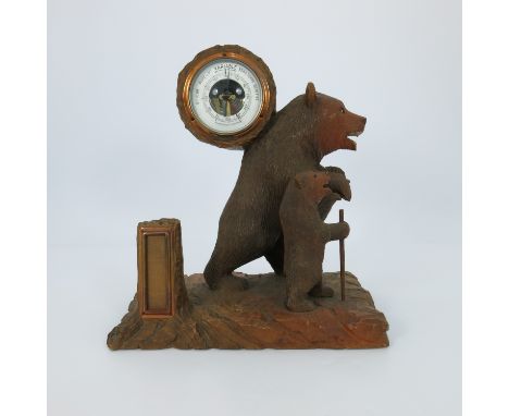 A Black Forest desk barometer, 20th Century, carved as a strolling bear with cub on a naturalistic plinth, 32cm high, 28cm wi