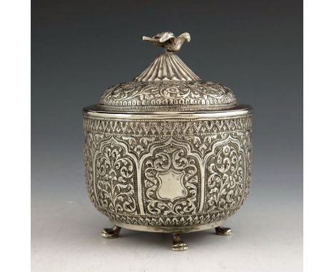 An Indian Kutch silver box and cover, or tea caddy, 19th century, rounded bowl form, repousse embossed and chased with ogee a