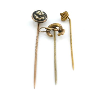 Three yellow metal stick pins, including riding crop and horseshoe, enamel and split pearl floral motif and revivalist rosett