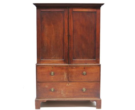 A George III mahogany linen press, circa 1800, plain moulded cornice, double panelled doors opening to a bank of slides, the 