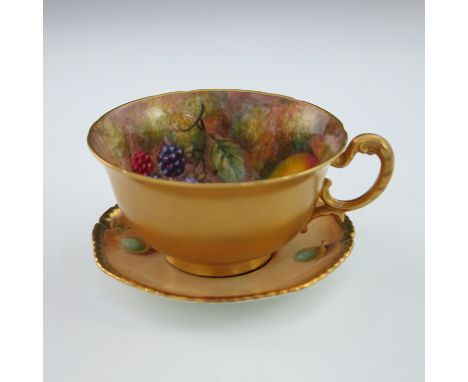 John Freeman for Royal Worcester, a fruit painted tea cup, circa 1957, decorated with peaches and berries on moss covered gro