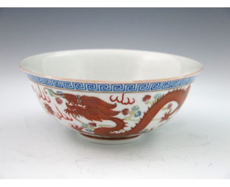 A Chinese bowl, gently flared rim, the exterior polychrome painted in raised enamels with a Greek key border containing a myt