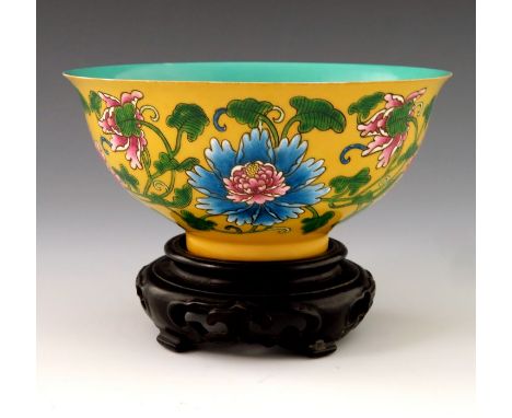 A Chinese polychrome bowl, Kangxi mark, ogee form, yellow ground, enamelled with flowers and scrolling foliage, turquoise int