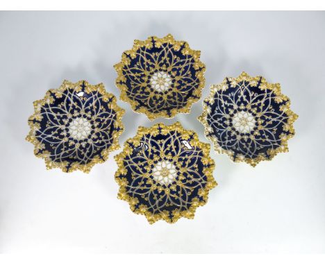 Four late 19th century Meissen plates, circular dished and denticulated form, relief moulded trailing vines and flowers on a 