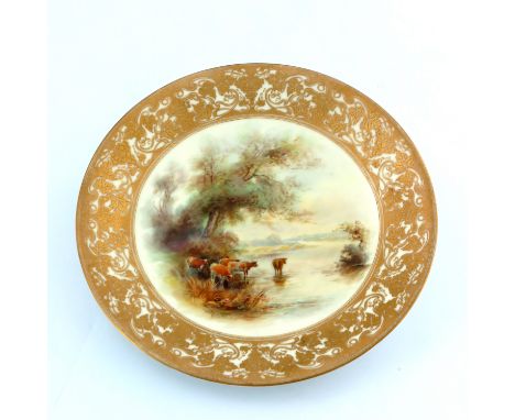 John Stinton for Royal Worcester, a cabinet plate, painted with a scene of cattle watering, raised gilt vine border, dated 19