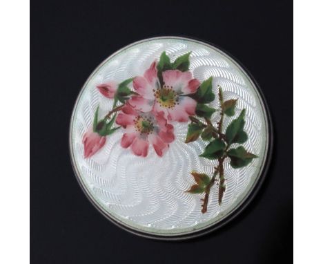 An Edwardian silver and enamelled pill box, Birmingham 1906, circular, with cream guilloche enamel and painted dog rose decor