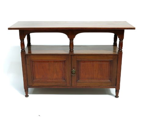 An Aesthetic Movement walnut buffet sideboard, circa 1880, the wide plank top on an open arcaded shelf with turned column sup