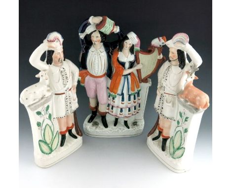 Two Staffordshire figures of huntsmen, circa 1860, modelled standing beside stone columns with fawns seated on top, on oval p