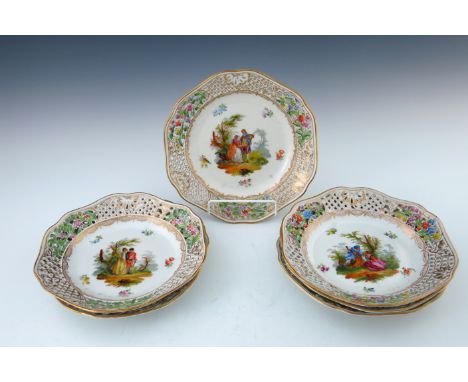 A set of six Potschappel porcelain cabinet plates, decorated with Watteau scenes, reticulated and gilt serpentine borders, ma