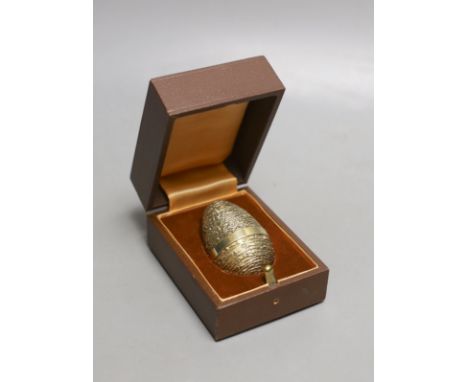 A cased modern silver gilt surprise egg, in the manner of Stuart Devlin, by Richard Lawrence Geere, London, 1976, 67mm, with 