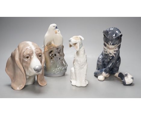 A Royal Copenhagen cat 304, love birds 649, dove 4727, a Lladro dog's head and a Nao figure of a yawning dog - tallest 19cm (