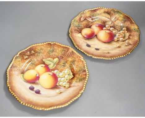 A pair of Royal Worcester fruit painted dinner plates, post war, by D. Shinnie and T. Nutt, 27cm diameter