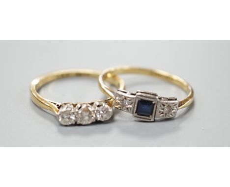 An 18ct and three stone diamond ring, size L/M and an 18ct, sapphire and diamond chip set three stone ring, gross weight 4 gr