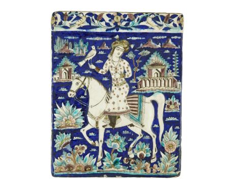 A Persian polychrome tile, Qajar dynasty - 34.5 x 27cm moulded in relief and painted with a nobleman on horseback holding a f