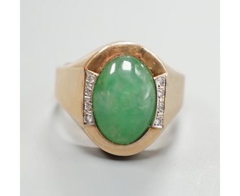 A 14k, cabochon jade and diamond chip set dress ring, size R/S, gross 7.6 grams.