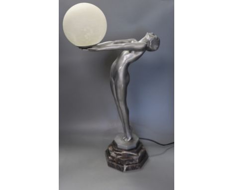 An Art Deco style figurative lamp of a lady holding a frosted glass globe,66cms high.