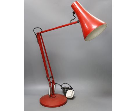 A red anglepoise desk lamp