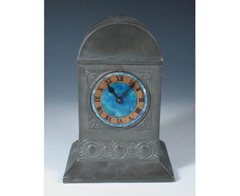 Attributed to Archibald Knox for Liberty & Co., a pewter and enamel mantle clock, the arched case with celtic knot motifs and