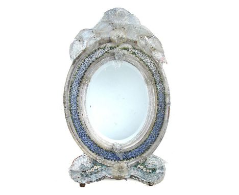 A late 19th century Venetian micro mosaic mirror, the oval plate glass to a surround of twisted glass bars and blown flower p