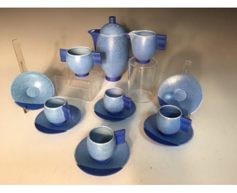 A Carlton Ware 'Moderne' coffee service, circa 1935, the ovoid shaped pieces with wavy handles and glazed in a mottled blue, 