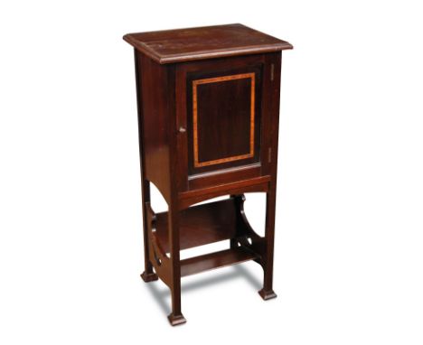 An early 20th century mahogany bedside cabinet, the inlaid cupboard door opening to reveal a pipe rack and shelf within above