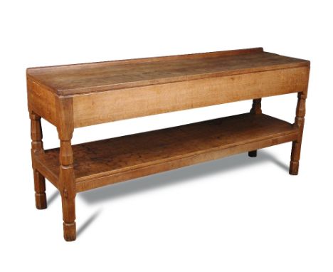 A Robert 'Mouseman' Thompson oak serving table/buffet, the adzed rectangular top above a second tier supported on four shaped