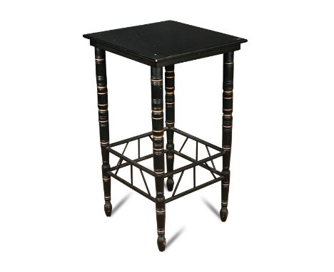 An ebonised occasional table, in the manner of E.W. Godwin, the square top raised on four ring-turned legs with gilt highligh