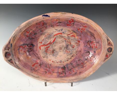 Quentin Bell, a Fulham Pottery oval dish, with central portrait head to a border of oak leaves, incised to verso "Fulham Pott