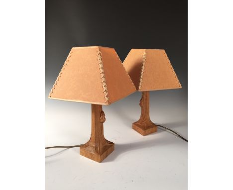 A pair of Robert 'Mouseman' Thompson oak table lamps, the octagonal columns with carved mouse signature, raised on square sec