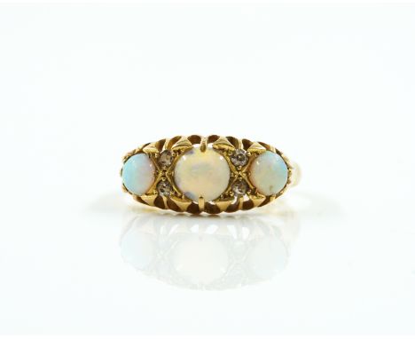 A GOLD, OPAL AND DIAMOND RINGSet with three cabochon opals and four small old cut diamonds, in a claw setting, in hallmarked 