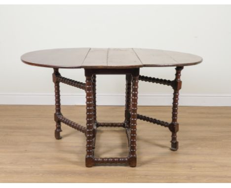 A 17TH CENTURY YEW WOOD GATE LEG TABLEOn bobbin turned base, 41cm across; 134cm across open; 108cm long