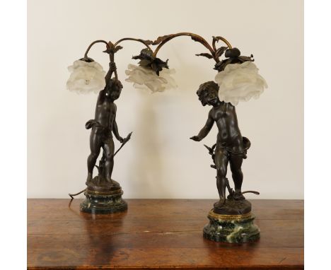 A PAIR OF FRENCH SPELTER FIGURAL LAMP BASES MODELLED AS CHERUBS (2)Each signed 'Ferrand', the central figure holding a two-li