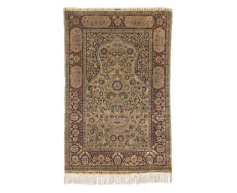 A silk Hereke rugWest Anatoliaon light brown ground, the whole filled with bold lotus flowers and interlacing palmettes132cm 
