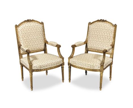 A pair of French late 19th/early 20th century giltwood fauteuilsin the Louis XVI styleEach with channelled and ribbon-and-ree