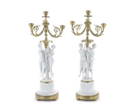 A pair of late 19th/early 20th century French gilt bronze and biscuit porcelain four light figural candelabrathe three acanth